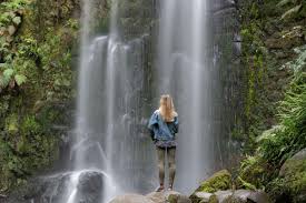 girl standing in front of waterfall